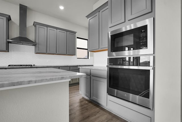 2904 Apple Rose, Katy, TX 77493 - kitchen featuring stainless steel appliances, backsplash, wall chimney range hood, and gray cabinets
