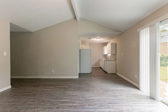unfurnished living room featuring baseboards, vaulted ceiling with beams, and wood finished floors