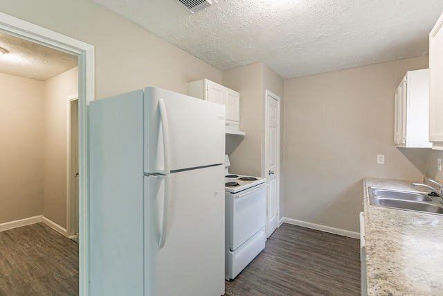 kitchen with a sink, under cabinet range hood, white appliances, and dark wood-style floors
