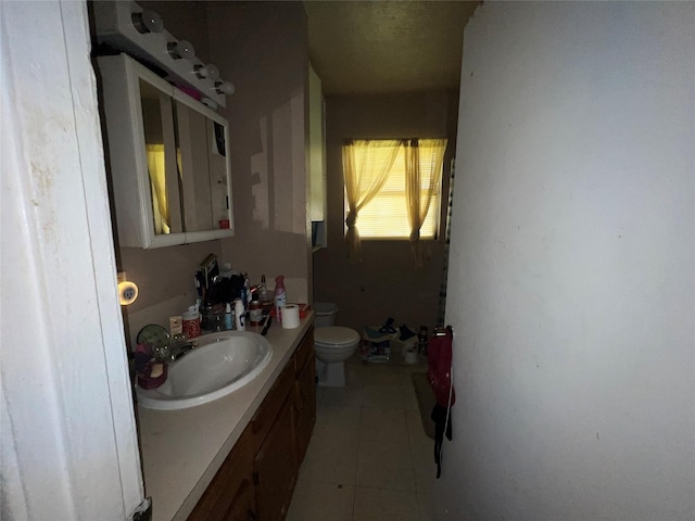 bathroom featuring toilet, vanity, and tile patterned floors