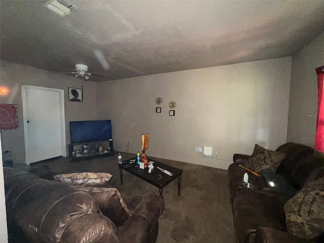 living area featuring carpet floors, visible vents, and a ceiling fan