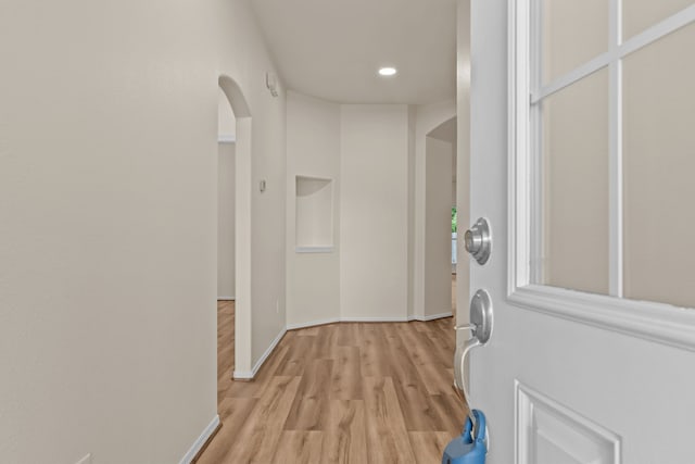 1069 Shadow Glenn Dr, Conroe, TX 77301 - interior space with light wood-style floors, baseboards, arched walkways, and recessed lighting