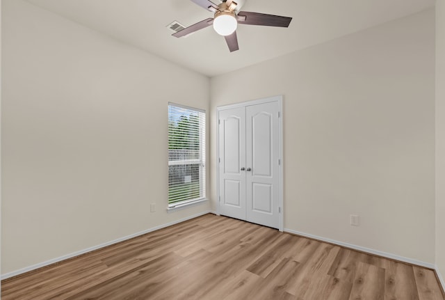 1069 Shadow Glenn Dr, Conroe, TX 77301 - unfurnished bedroom with a ceiling fan, a closet, light wood-style flooring, baseboards, and visible vents