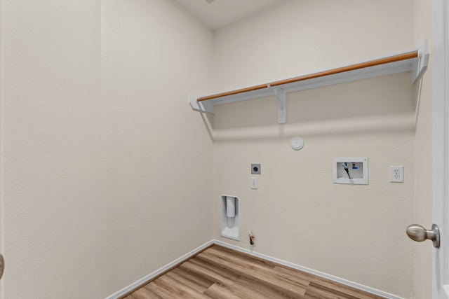 1069 Shadow Glenn Dr, Conroe, TX 77301 - laundry area featuring laundry area, hookup for an electric dryer, light wood-style flooring, hookup for a gas dryer, and washer hookup