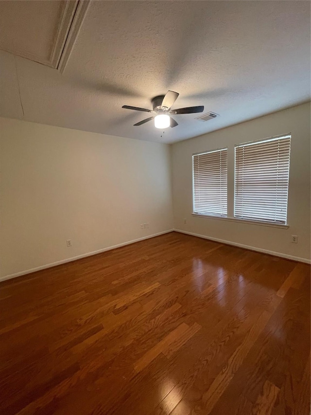 4311 Lakeside Meadow Dr, Missouri City, TX 77459 - empty room with a ceiling fan, attic access, wood finished floors, a textured ceiling, and visible vents
