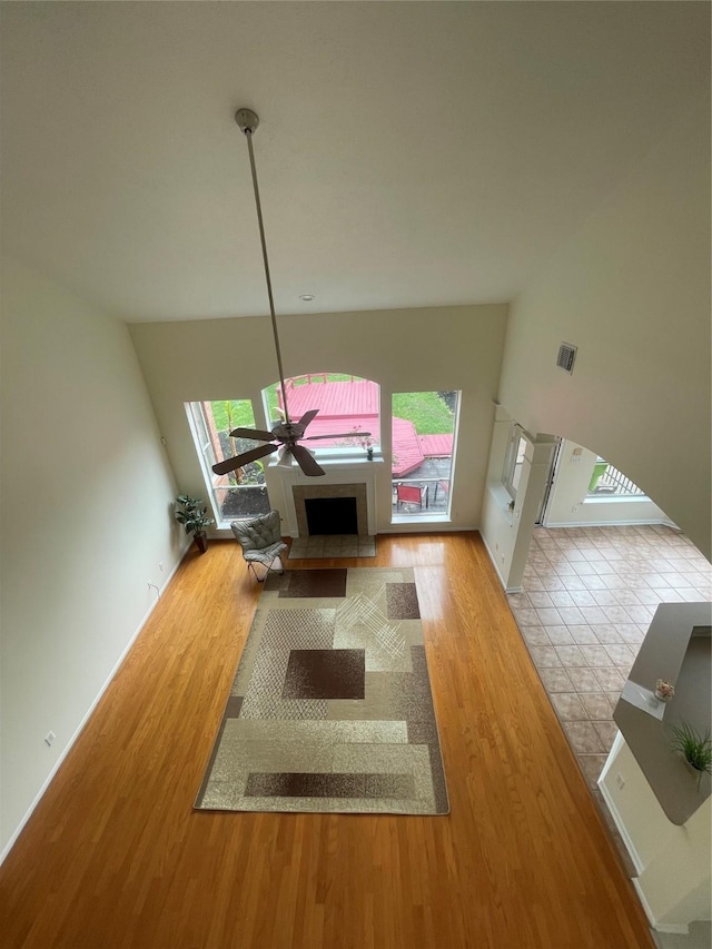 4311 Lakeside Meadow Dr, Missouri City, TX 77459 - unfurnished living room featuring baseboards, ceiling fan, visible vents, a fireplace, and wood finished floors