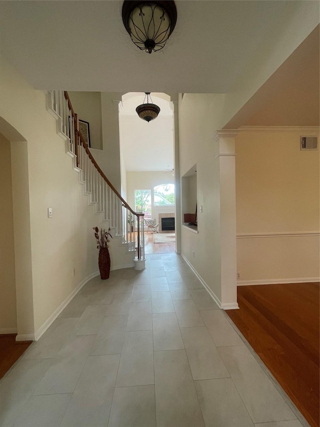 4311 Lakeside Meadow Dr, Missouri City, TX 77459 - corridor with visible vents, baseboards, stairs, tile patterned floors, and a high ceiling