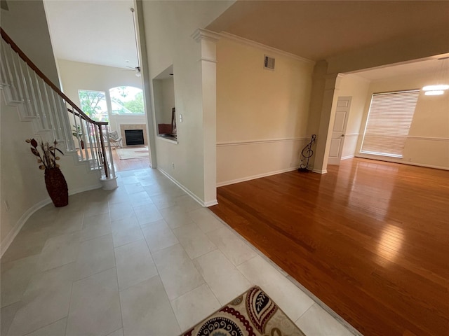 4311 Lakeside Meadow Dr, Missouri City, TX 77459 - corridor with stairway, light wood finished floors, baseboards, visible vents, and ornamental molding