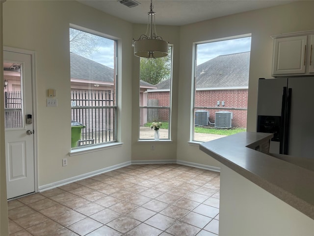 4311 Lakeside Meadow Dr, Missouri City, TX 77459 - unfurnished dining area with plenty of natural light, baseboards, visible vents, and light tile patterned floors