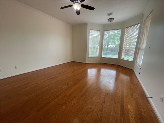 4311 Lakeside Meadow Dr, Missouri City, TX 77459 - unfurnished room with ornamental molding, baseboards, ceiling fan, visible vents, and wood finished floors
