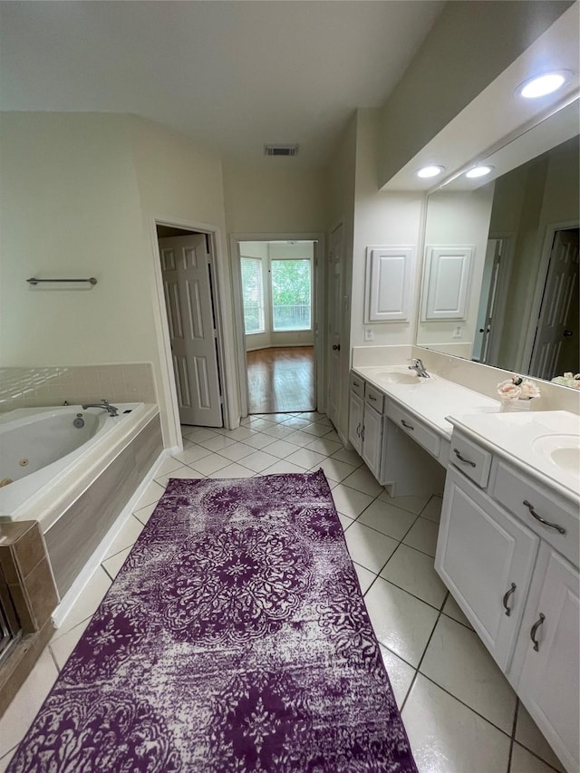 4311 Lakeside Meadow Dr, Missouri City, TX 77459 - bathroom featuring tile patterned floors, a sink, a whirlpool tub, visible vents, and double vanity