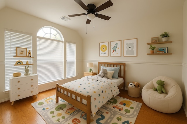 4311 Lakeside Meadow Dr, Missouri City, TX 77459 - bedroom featuring visible vents, a ceiling fan, wood finished floors, and vaulted ceiling