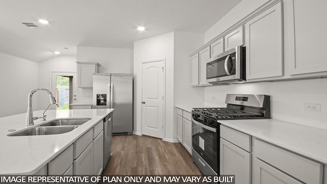 1342 Heather Rosewood Ln, Conroe, TX 77301 - kitchen with stainless steel appliances, a sink, dark wood finished floors, light countertops, and recessed lighting