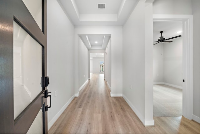 10017 Larkin Cv, Willis, TX 77318 - corridor with a tray ceiling, light wood finished floors, and attic access