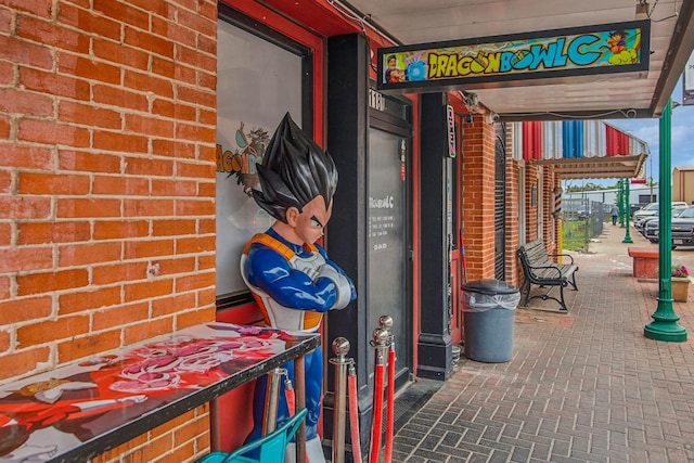 exterior space with brick floor and brick wall