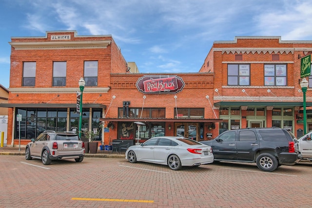 view of building exterior featuring uncovered parking