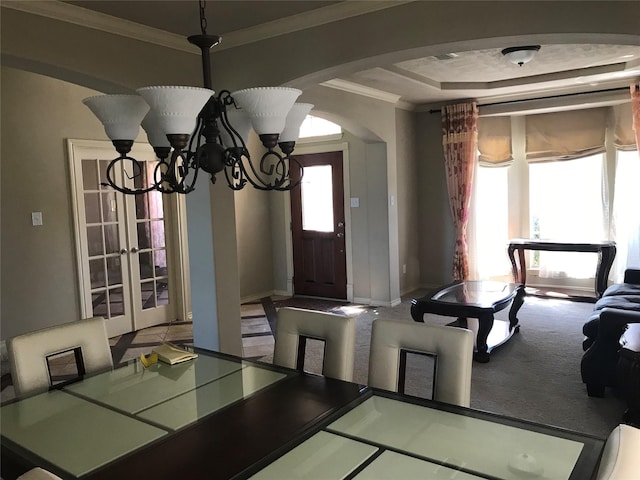 8007 Furleson Dr, Rosenberg, TX 77469 - carpeted dining room with a tray ceiling, ornamental molding, baseboards, a chandelier, and arched walkways