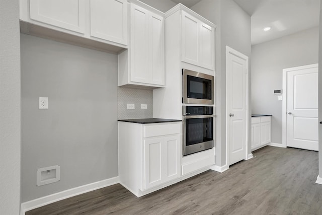 2916 Apple Rose, Katy, TX 77493 - kitchen featuring decorative backsplash, oven, wood finished floors, and built in microwave