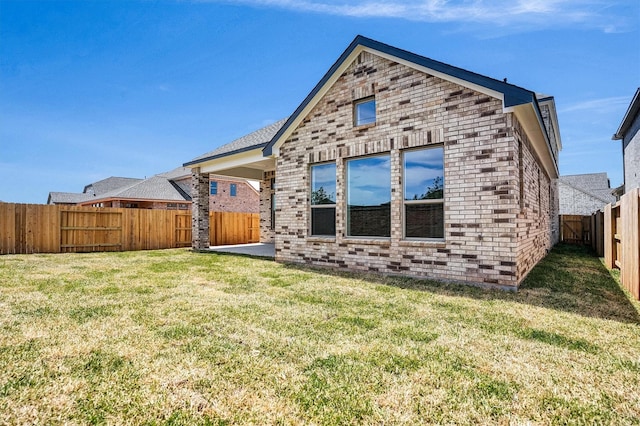 2916 Apple Rose, Katy, TX 77493 - rear view of house featuring brick siding, a lawn, and a fenced backyard