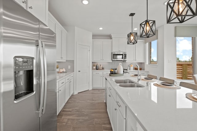 15850 Invergelder Dr, Atascocita, TX 77346 - kitchen featuring recessed lighting, a sink, white cabinets, and appliances with stainless steel finishes