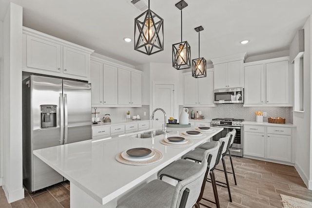 15850 Invergelder Dr, Atascocita, TX 77346 - kitchen with appliances with stainless steel finishes, white cabinetry, recessed lighting, and a sink