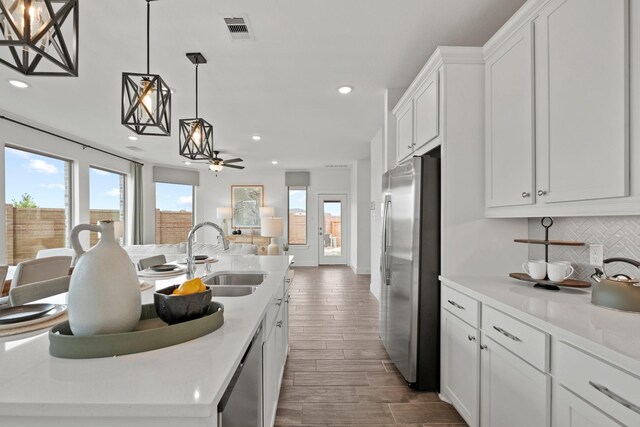 15850 Invergelder Dr, Atascocita, TX 77346 - kitchen with visible vents, stainless steel appliances, recessed lighting, and a sink