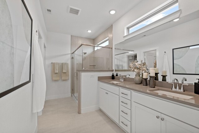 15850 Invergelder Dr, Atascocita, TX 77346 - bathroom with visible vents, a stall shower, double vanity, and a sink