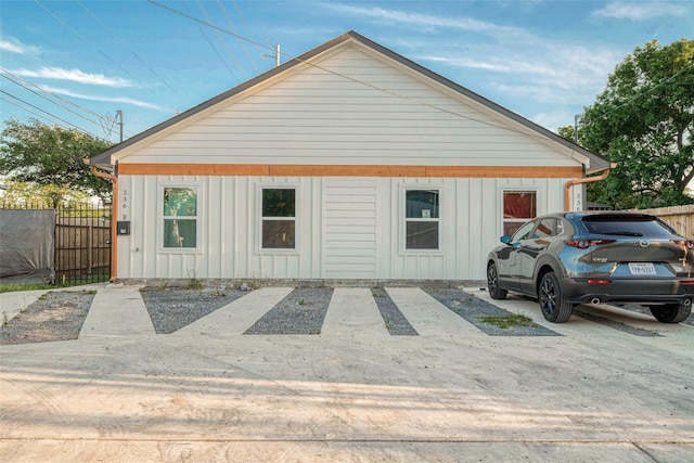exterior space with board and batten siding and fence