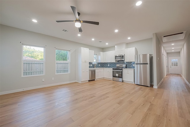 kitchen with visible vents, ceiling fan, backsplash, and stainless steel appliances