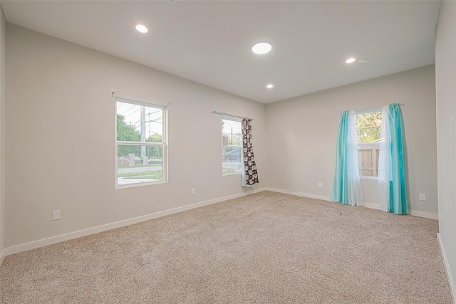 unfurnished room with carpet floors, baseboards, and recessed lighting