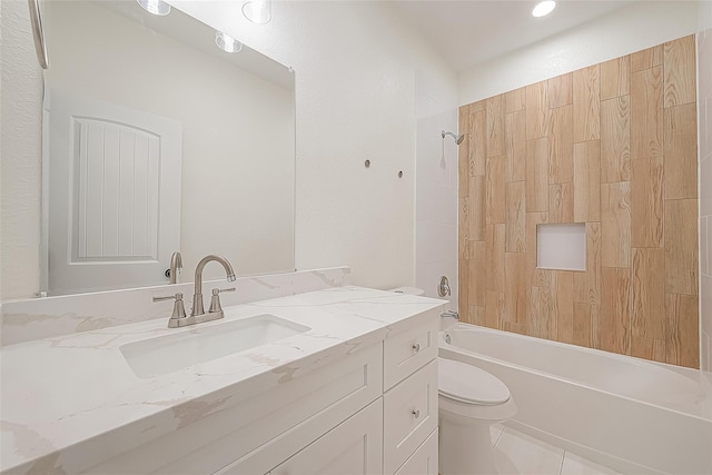 bathroom featuring toilet, vanity, and bathing tub / shower combination