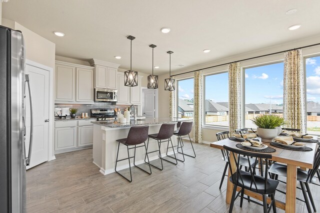 15854 Invergelder Dr, Atascocita, TX 77346 - kitchen featuring stainless steel appliances, decorative backsplash, healthy amount of natural light, baseboards, and recessed lighting