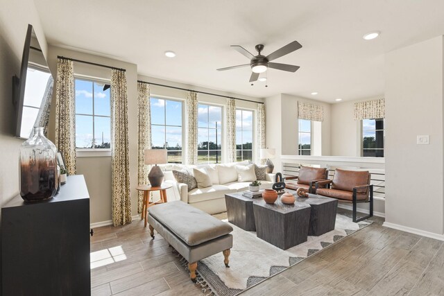 15854 Invergelder Dr, Atascocita, TX 77346 - living room featuring light wood-type flooring, baseboards, a ceiling fan, and recessed lighting