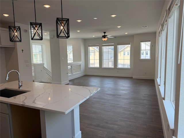 15854 Invergelder Dr, Atascocita, TX 77346 - kitchen with a sink, recessed lighting, a ceiling fan, baseboards, and dark wood-type flooring