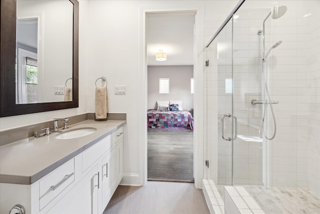 bathroom featuring vanity, connected bathroom, and a shower stall