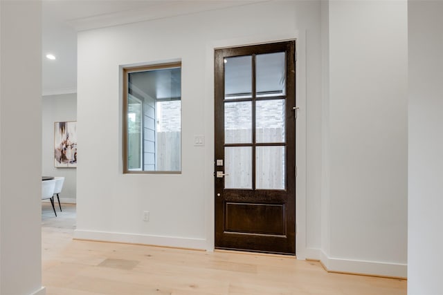 626 E 14th St, Houston, TX 77008 - foyer entrance with baseboards, light wood-type flooring, and crown molding