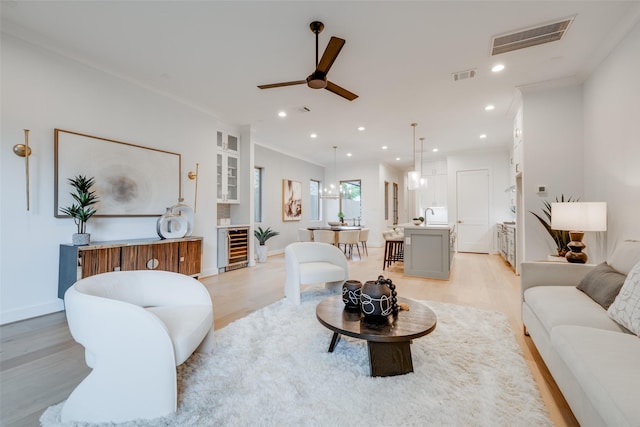 626 E 14th St, Houston, TX 77008 - living area featuring light wood-style floors, ceiling fan, ornamental molding, beverage cooler, and recessed lighting