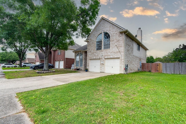 231 Spencer Lndg E, La Porte, TX 77571 - view of front of house featuring a garage, a chimney, brick siding, and driveway