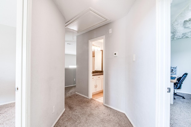 231 Spencer Lndg E, La Porte, TX 77571 - hallway with attic access, light carpet, and baseboards