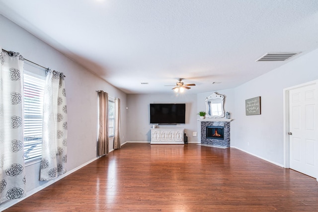 231 Spencer Lndg E, La Porte, TX 77571 - unfurnished living room featuring ceiling fan, wood finished floors, a fireplace, and baseboards