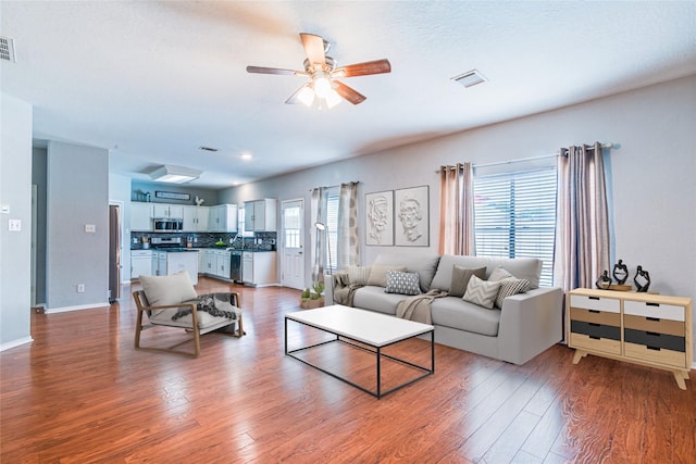 231 Spencer Lndg E, La Porte, TX 77571 - living room featuring wood finished floors, ceiling fan, and baseboards