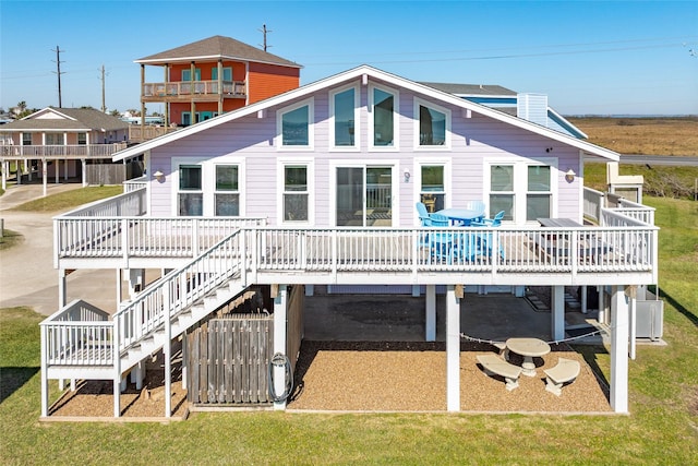 4406 Tampico Way, Galveston, TX 77554 - rear view of property with stairs, a wooden deck, and a yard