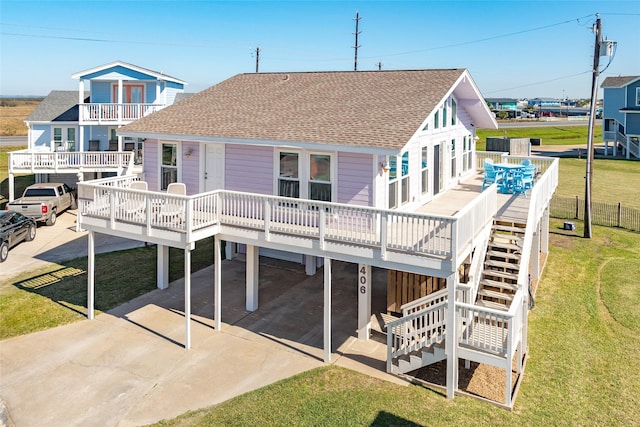 4406 Tampico Way, Galveston, TX 77554 - rear view of property with stairs, driveway, a yard, and roof with shingles