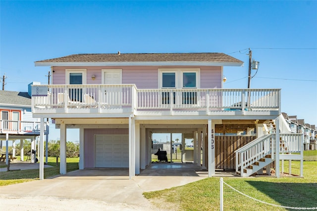 4406 Tampico Way, Galveston, TX 77554 - coastal home with a garage, concrete driveway, stairway, a porch, and a carport