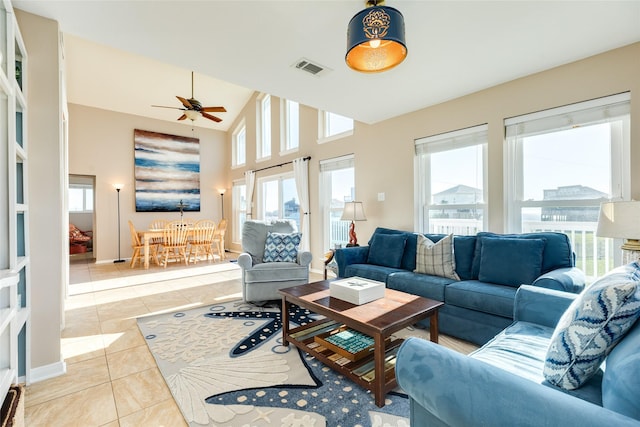 4406 Tampico Way, Galveston, TX 77554 - living area featuring light tile patterned flooring, visible vents, baseboards, a towering ceiling, and a ceiling fan