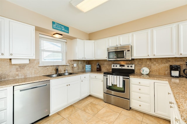 4406 Tampico Way, Galveston, TX 77554 - kitchen featuring backsplash, white cabinets, a sink, and appliances with stainless steel finishes