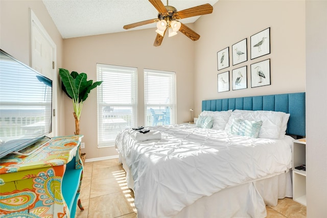 4406 Tampico Way, Galveston, TX 77554 - bedroom featuring baseboards, lofted ceiling, a textured ceiling, and light tile patterned floors