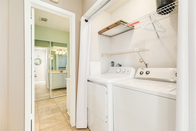 4406 Tampico Way, Galveston, TX 77554 - laundry area with light tile patterned floors, a sink, separate washer and dryer, and visible vents