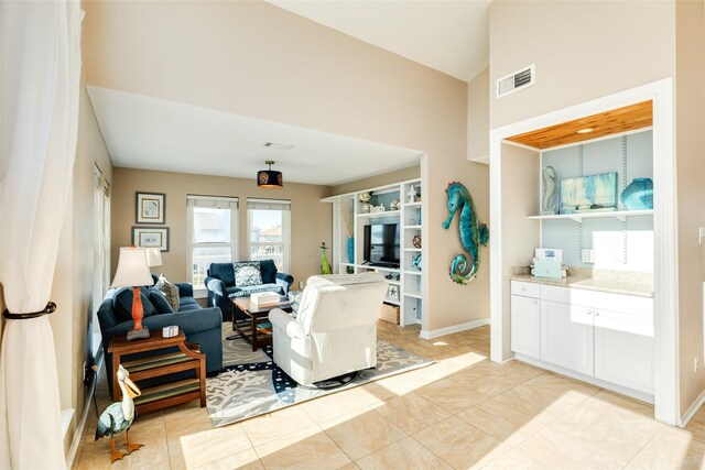 4406 Tampico Way, Galveston, TX 77554 - living room with light tile patterned floors, high vaulted ceiling, baseboards, and visible vents