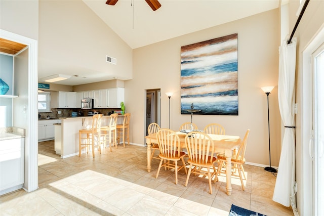 4406 Tampico Way, Galveston, TX 77554 - dining room with baseboards, high vaulted ceiling, ceiling fan, and visible vents